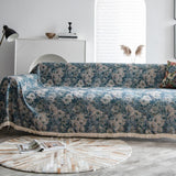 Blue Bouquet floral throw styled on a sofa with an arc lamp, console and pampas grass