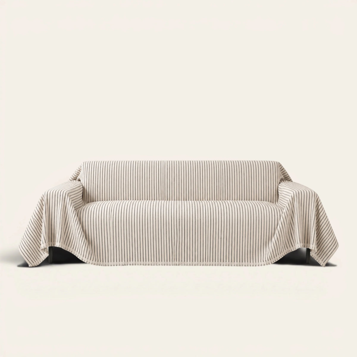 Charcoal Gray Classic Pinstripe sofa throw draped over a three seater sofa, front view on ivory background