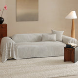 Charcoal Gray Classic Pinstripe throw covering a sofa in a bright living room with floor lamp, art and pink blooms