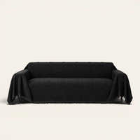 Ebony elegance Classic Striped sofa throw in black, draped over a couch on an ivory backdrop with fringe