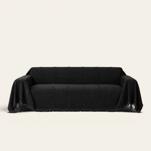 Ebony elegance Classic Striped sofa throw in black, draped over a couch on an ivory backdrop with fringe