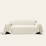 Ivory Whisper Classic Striped sofa throw draped over a two-seat sofa, front view on ivory background, tufted stripes and fringed hem