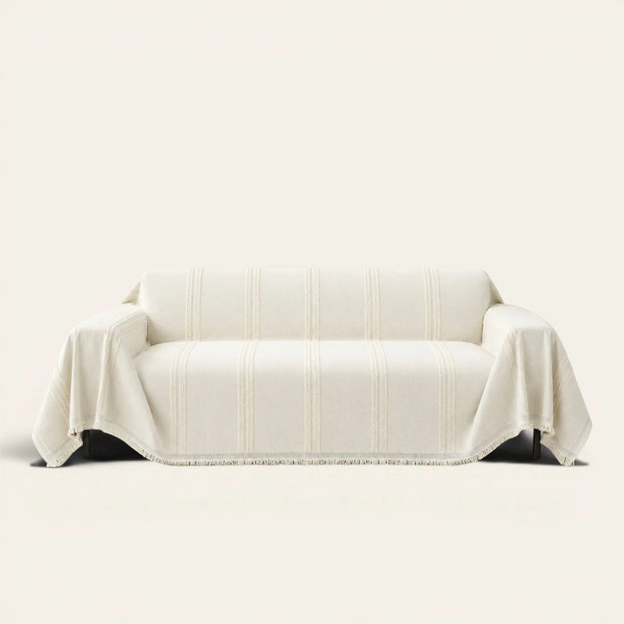 Ivory Whisper Classic Striped sofa throw draped over a two-seat sofa, front view on ivory background, tufted stripes and fringed hem