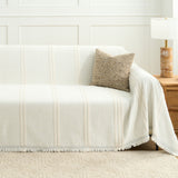 Ivory Whisper Classic Striped throw styled on a sofa in a bright room with a woven cushion and wooden side lamp