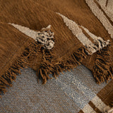 Close-up of Mocha Harmony Classic Striped throw folded, tufted cream stripes and woven base with fringe