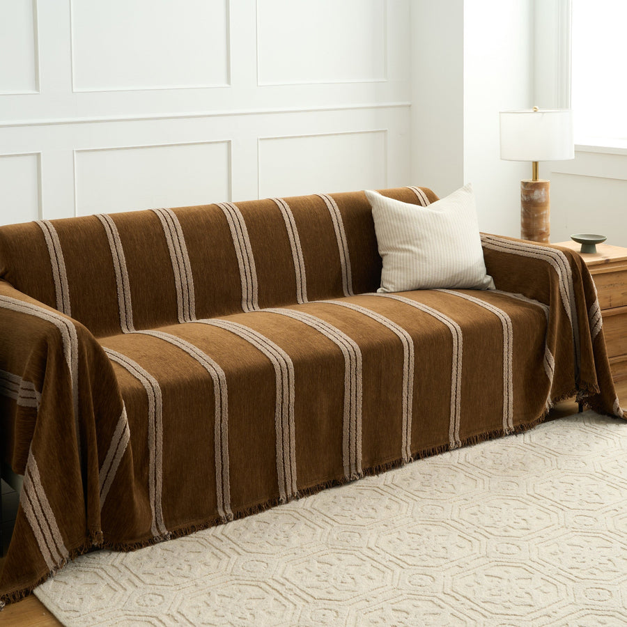 Mocha Harmony Classic Striped throw over a sofa in a paneled room with a cushion, lamp and patterned rug