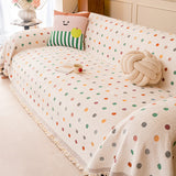 Cream multi Color Dot polka dot throw styled on a sofa with playful cushions, a book and a cup