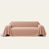Cozy Chic sofa throw in Blush Pink over a couch, front view with a plush bubble textured surface