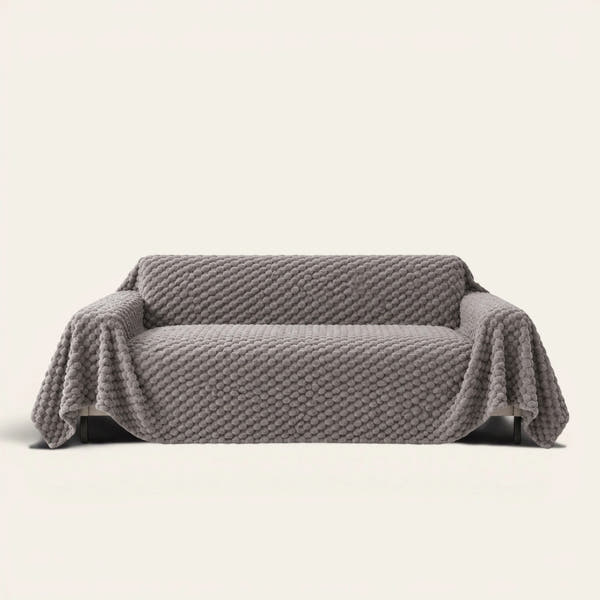 Slate Gray Cozy Chic sofa throw draped over a full couch, front view on ivory background