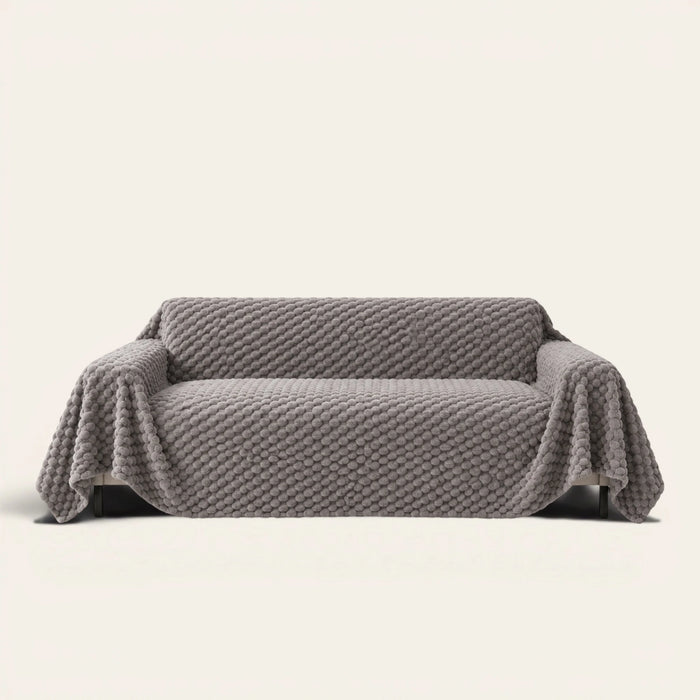 Slate Gray Cozy Chic sofa throw draped over a full couch, front view on ivory background