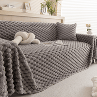Slate Gray Cozy Chic throw styled on a corner sofa with a knot cushion and roses
