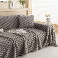 Slate Gray Cozy Chic throw over a sofa with cushion, book and coffee in a bright room