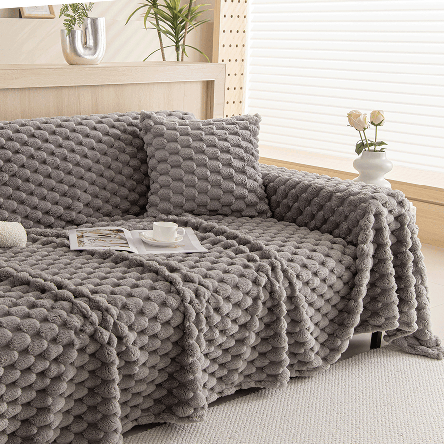 Slate Gray Cozy Chic throw over a sofa with cushion, book and coffee in a bright room