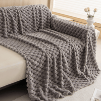 Angled cascade fold of the Slate Gray Cozy Chic throw draped over a sofa corner