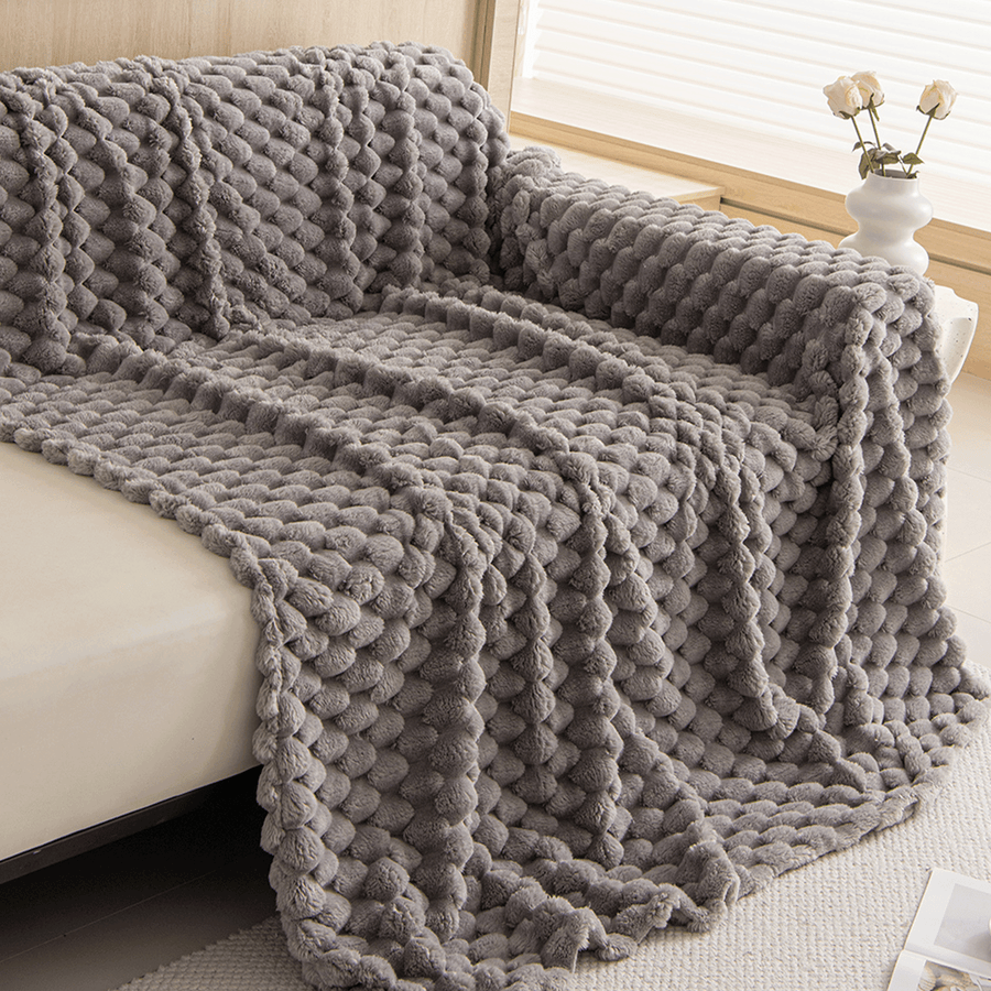 Angled cascade fold of the Slate Gray Cozy Chic throw draped over a sofa corner