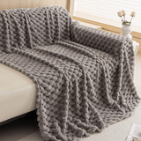 Angled cascade fold of the Slate Gray Cozy Chic throw draped over a sofa corner