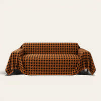Coffee Brown Cozy Houndstooth sofa throw draped over a three seater sofa, front view on ivory background