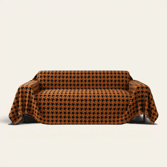 Coffee Brown Cozy Houndstooth sofa throw draped over a three seater sofa, front view on ivory background