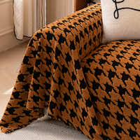 Close view of Coffee Brown Cozy Houndstooth throw draped over the sofa arm showing plush houndstooth texture