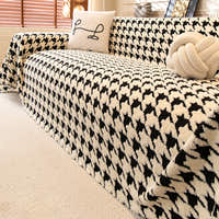 Ivory Black Cozy Houndstooth throw styled on a sofa with cushions in a cozy living room