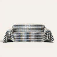 Cozy Houndstooth Ocean Blue sofa throw draped over a three-seat sofa, front view on ivory