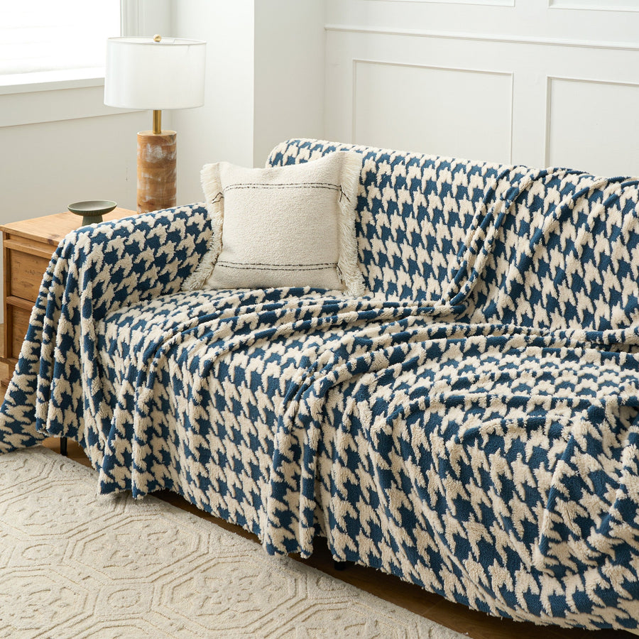 Ocean Blue Cozy Houndstooth throw over a sofa corner with cream cushion and nightstand