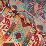 Close-up of the draped kilim folds with teal and orange geometric bands