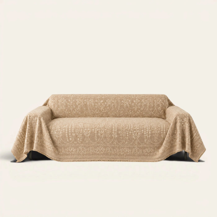 French Vintage Oat Beige sofa throw draped over a three-seat sofa, front view on ivory