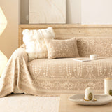 Oat Beige French Vintage throw styled on a sofa with boucle cushion and travertine wall