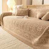 French Vintage Oat Beige throw on a sofa with knot and boucle cushions, angled view