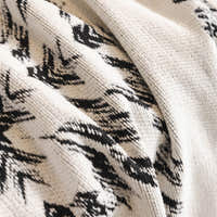 Macro of the woven Ivory Ink fabric showing the Fringed Boho black medallion pattern