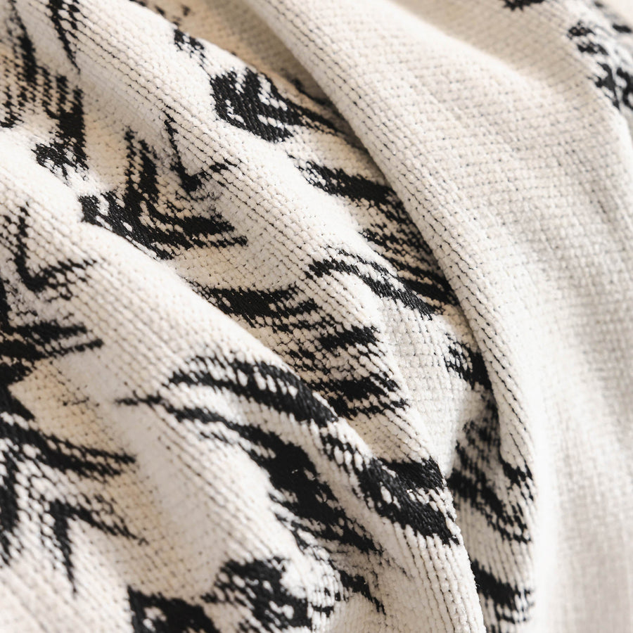 Macro of the woven Ivory Ink fabric showing the Fringed Boho black medallion pattern