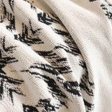 Macro of the woven Ivory Ink fabric showing the Fringed Boho black medallion pattern