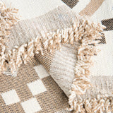 Macro of the fringed tasseled edge and reversible weave of the Beige Geometry throw