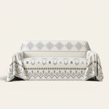 Geometric Boho sofa throw in Gray Geometry draped over a couch, front view on ivory background