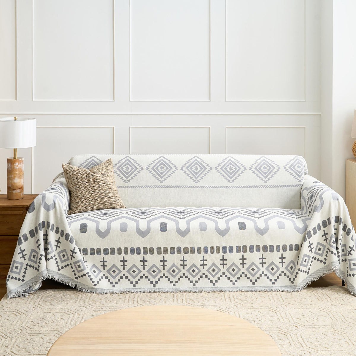 Gray Geometry Geometric Boho throw styled on a sofa with a knit cushion in a bright living room