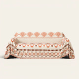 Orange Geometry geometric boho throw draped over a two-seat sofa, front view on ivory background