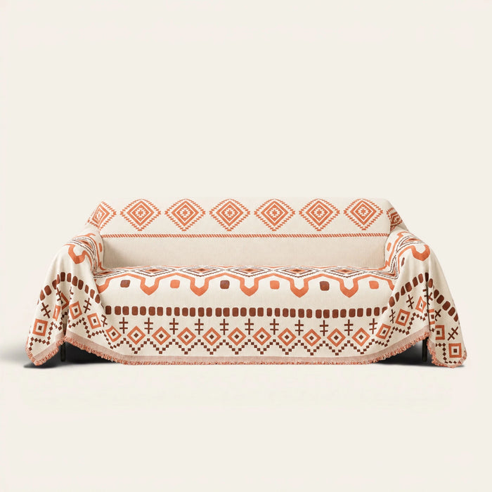 Orange Geometry geometric boho throw draped over a two-seat sofa, front view on ivory background