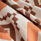 Macro of the woven boho fabric showing orange and brown geometric motifs