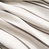 Close-up of the striped chenille fabric folds of the Black Linearity throw
