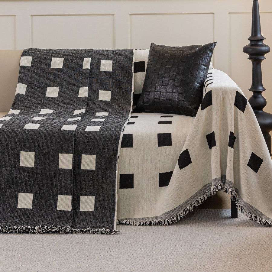 Checkered Onyx Geometric Chenille throw showing its reversible black and cream square sides