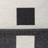 Macro of the Checkered Onyx Geometric Chenille fabric showing woven black squares on cream