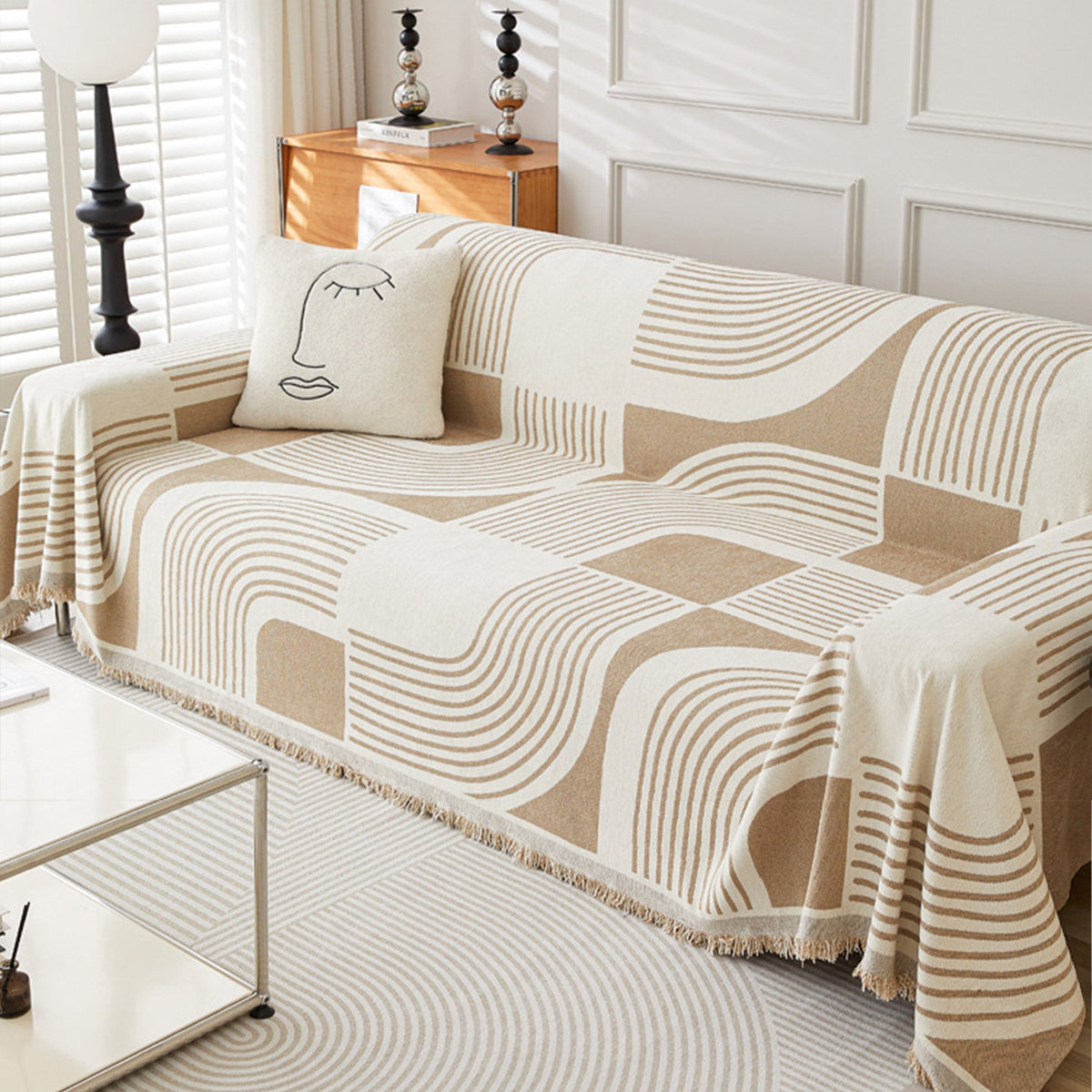 Brown Stream Geometric Harmony throw covering a sofa in a bright living room with wood sideboard and line-art cushion