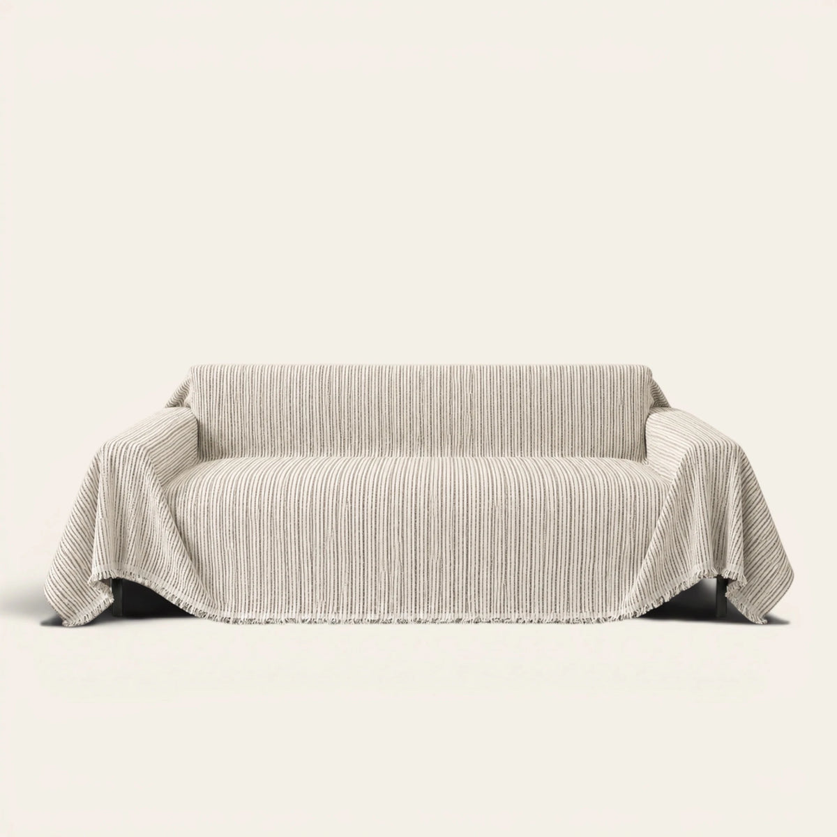 Charcoal Stripe Linear Weave sofa throw draped over a three seater sofa, front view on ivory background