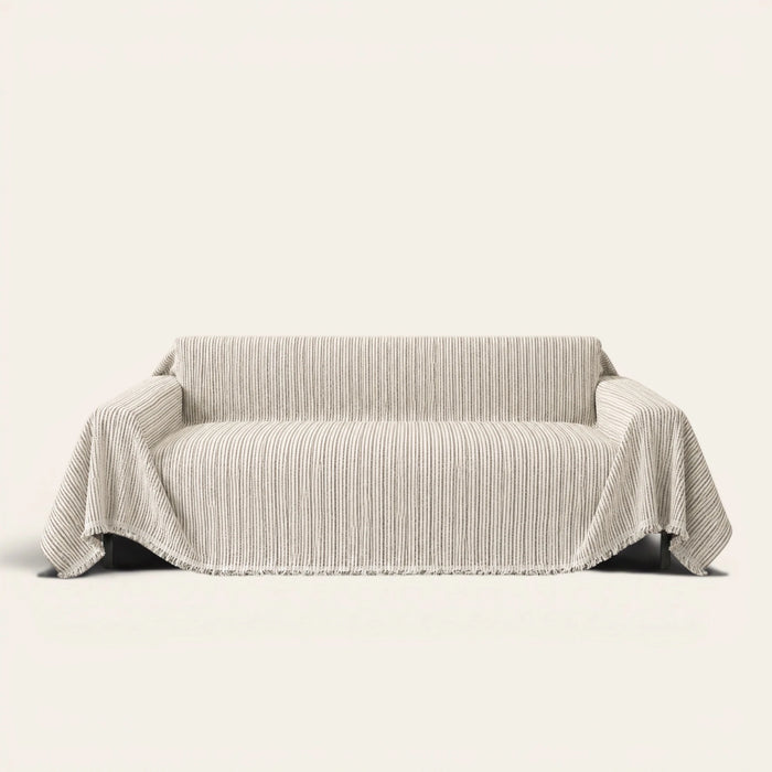 Charcoal Stripe Linear Weave sofa throw draped over a three seater sofa, front view on ivory background