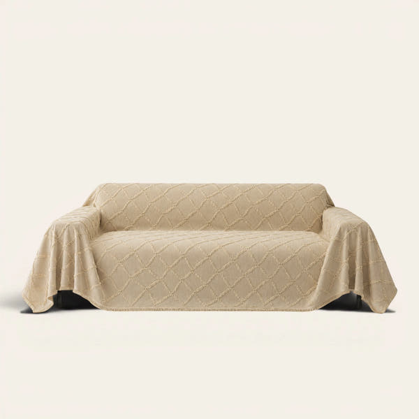Luxe Diamond Oat Beige sofa throw draped over a three-seat sofa, front view on ivory