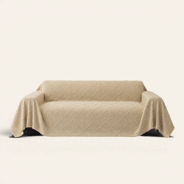 Luxe Diamond Oat Beige sofa throw draped over a three-seat sofa, front view on ivory