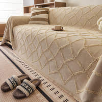 Close view of the tufted Luxe Diamond lattice on the Oat Beige throw over a sofa seat