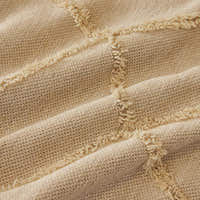 Macro of the Oat Beige fabric showing the raised tufted Luxe Diamond lattice texture