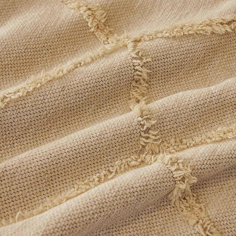 Macro of the Oat Beige fabric showing the raised tufted Luxe Diamond lattice texture